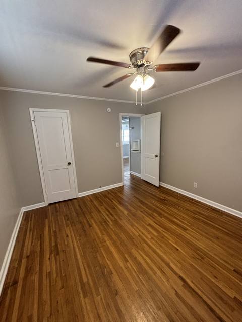 Refinished room with wood floor, fresh paint, and new ceiling fan