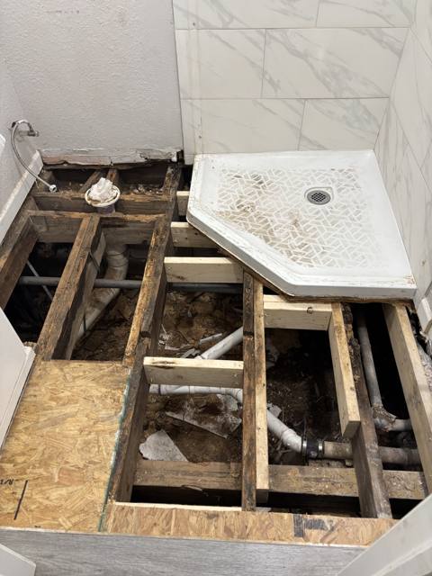 Bathroom during: floor opened to the joists, new shower pan set