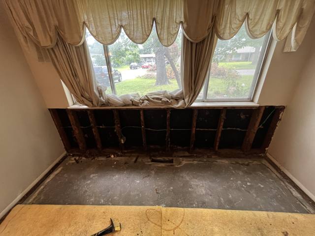 Window wall before: sill demolished, damage exposed