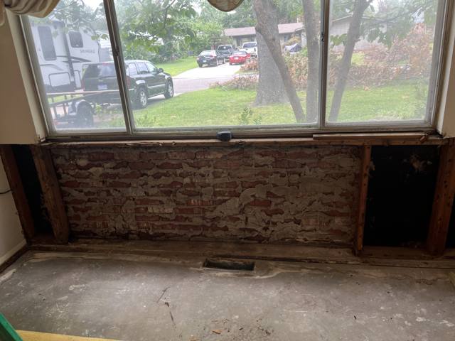 Window wall before: wall opened down to the brick