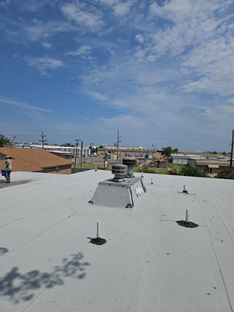 Finished commercial flat roof under a blue sky