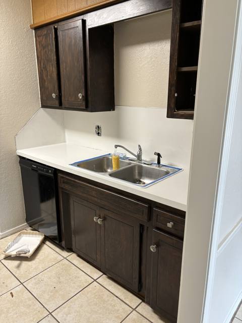 Kitchen after: cleaned and rebuilt wall with cabinets and counter reset