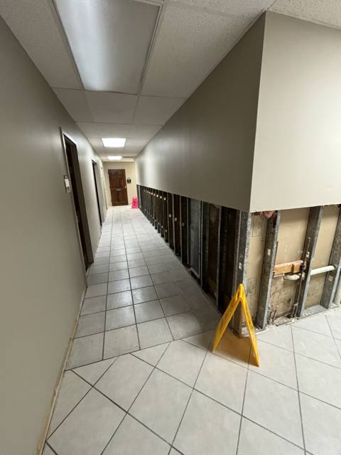 Commercial hallway during: finish work down the corridor